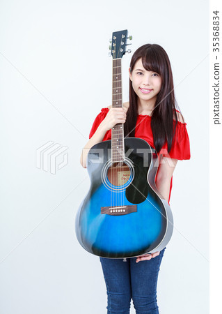 Young Woman Holding a Guitar Blue Folk Guitar Young Woman Holding a Guitar Blue Folk Guitar 35368834