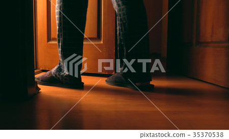 Adult man walks to a bathroom at the night 35370538