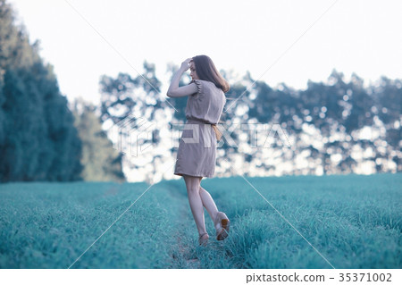 Happy girl running in the summer field Happy girl running in the summer field 35371002