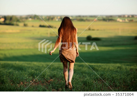 Happy girl running in the summer field Happy girl running in the summer field 35371004