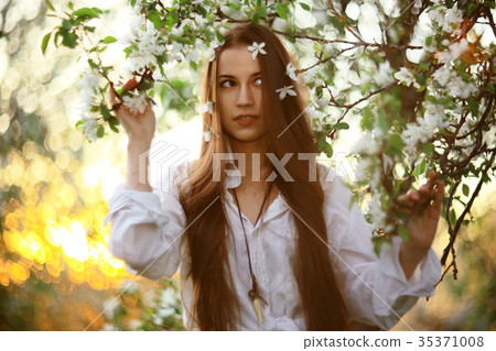 Spring portrait in apple blossoms young adult beautiful girl Spring portrait in apple blossoms young adult beautiful girl 35371008
