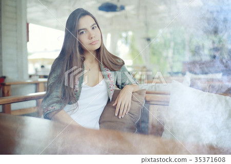 Glamorous portrait of a beautiful brunette with long hair Glamorous portrait of a beautiful brunette with long hair 35371608