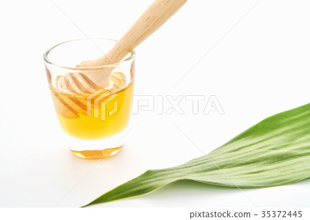 Honey glass and spoon have round shape for easy 35372445