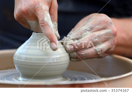 Potter making ceramic pot on the pottery wheel Potter making ceramic pot on the pottery wheel 35374167