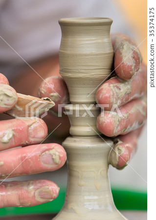 Potter making ceramic pot on the pottery wheel Potter making ceramic pot on the pottery wheel 35374175