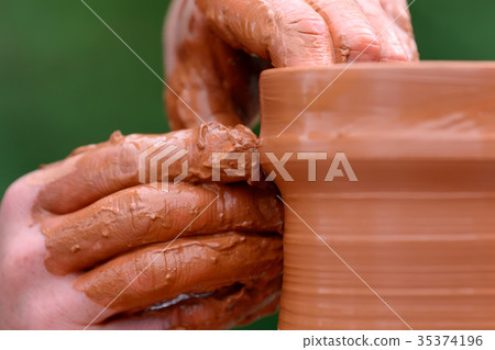 Potter making ceramic pot on the pottery wheel Potter making ceramic pot on the pottery wheel 35374196
