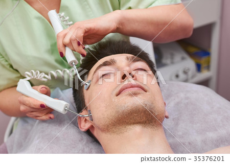 Face of man, microcurrent therapy. Face of man, microcurrent therapy. 35376201