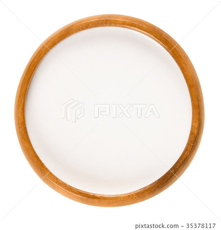 Almond milk in wooden bowl over white Almond milk in wooden bowl over white 35378117