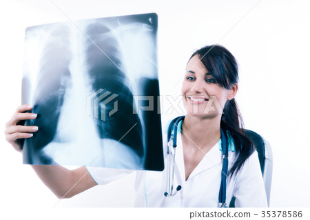 Young female doctor looking at the x-ray picture Young female doctor looking at the x-ray picture 35378586