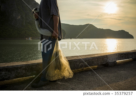 man and fishery net in hand  35379257