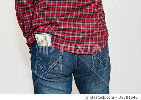 Person in checkered shirt with money in pocket Person in checkered shirt with money in pocket 35381640