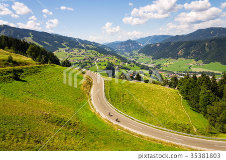 Cyclists in valley with Schladming, Austria 35381803