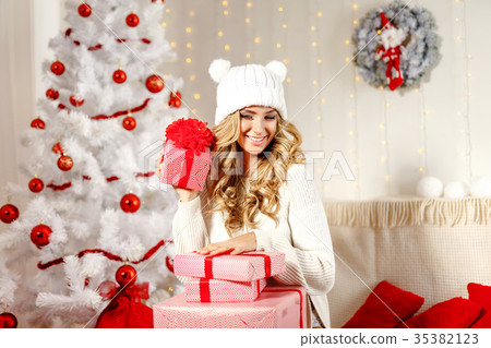 Charming model posing with Christmas presents Charming model posing with Christmas presents 35382123