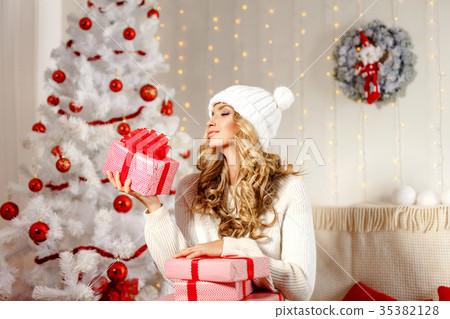 Charming model posing with Christmas presents Charming model posing with Christmas presents 35382128