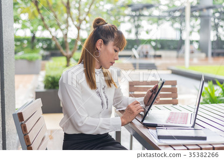 Elegant modern business woman working on tablet 35382266