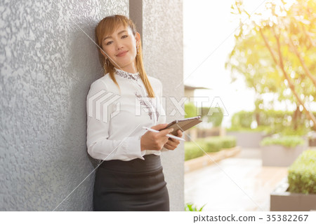 Asian woman using tablet Asian woman using tablet 35382267