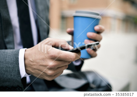 young businessman using a smartphone young businessman using a smartphone 35385017