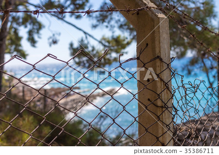 Beautiful and Blur Blue Sea View back of fence. 35386711