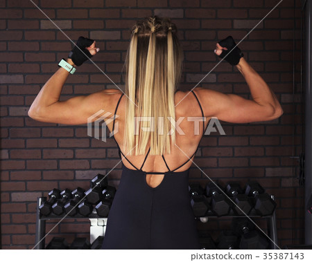 Fitness model posing in the gym 35387143