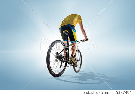 The bicyclist on gray, studio shot. The bicyclist on gray, studio shot. 35387494