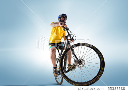 The bicyclist on gray, studio shot. The bicyclist on gray, studio shot. 35387588