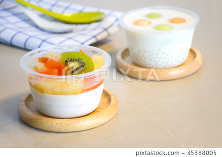 Pudding fruit salad cups with napkin and spoon Pudding fruit salad cups with napkin and spoon 35388005