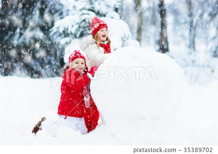 Kids building snowman. Children in snow Winter fun 35389702
