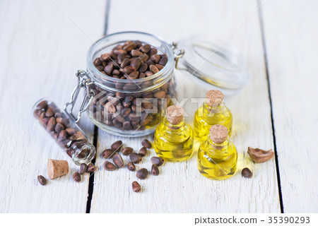 The cedar oil in a glass bottle 35390293