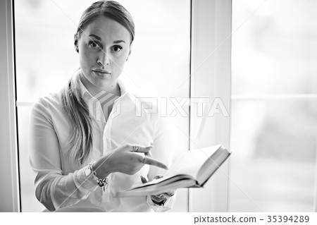 Young adult girl with book learning, reading, business Young adult girl with book learning, reading, business 35394289
