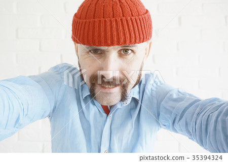 guy with a mustache in a red knitted hat 35394324
