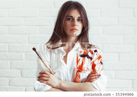 Young artist girl at work in the workshop brush paints canvas inspiration Young artist girl at work in the workshop brush paints canvas inspiration 35394966