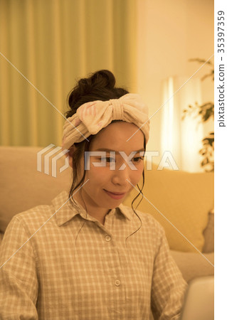 Woman who sees a PC in the room at night while taking an aroma 35397359