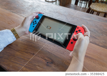 woman hands holding game portable woman hands holding game portable 35398425