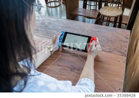 woman hands holding game portable woman hands holding game portable 35398426