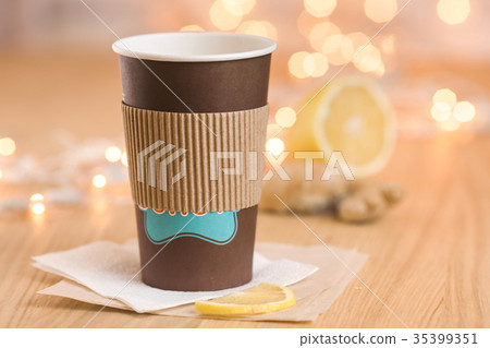 Tea with lemon and ginger in a paper cup 35399351