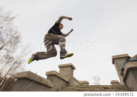 Wide angle view - parkour jumping in winter snow 35399572