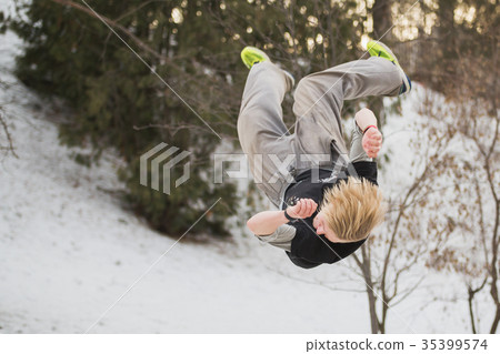 Backflip parkour jumping in winter snow park - 35399574