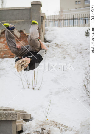 Teenager blonde hair guy training parkour jump 35399575
