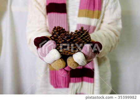 Hand hold gold and red ornament with sweater scarf Hand hold gold and red ornament with sweater scarf 35399982