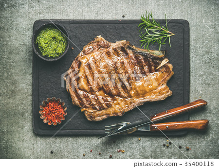 Grilled hot rib-eye beef steak on bone with Grilled hot rib-eye beef steak on bone with 35400118