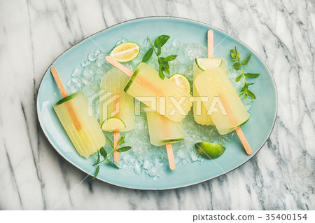 Summer lemonade popsicles with lime, mint leaves 35400154