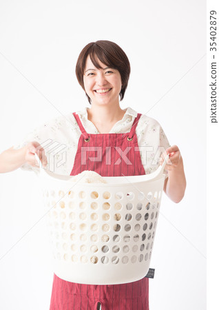 Japanese woman with a laundry basket smiles 35402879