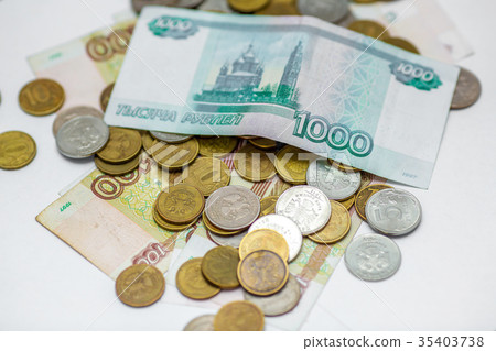 russian banknotes on a coins background russian banknotes on a coins background 35403738