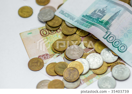 russian banknotes on a coins background russian banknotes on a coins background 35403739