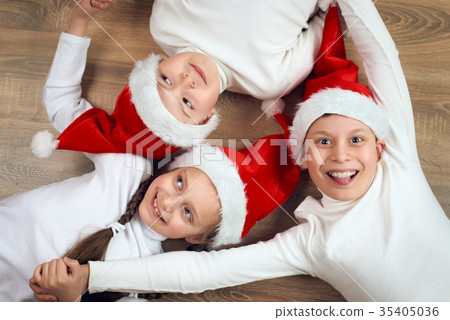 happy child dressed christmas Santa hat hold hands 35405036