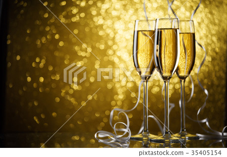 Picture of three glasses with champagne on gold Picture of three glasses with champagne on gold 35405154