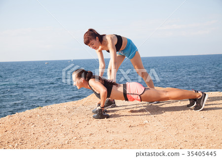 woman goes in for Sports Fitness on the beach 35405445