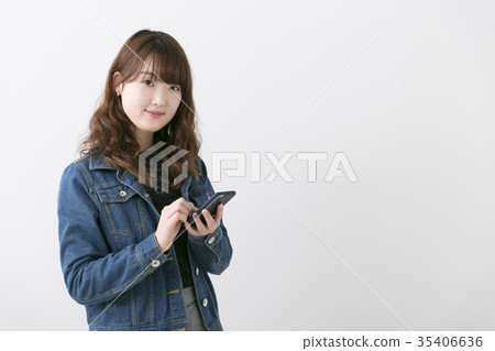 Woman using a smartphone Woman using a smartphone 35406636