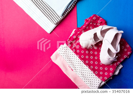 Folded blue and pink bodysuit with boat shoes on 35407016