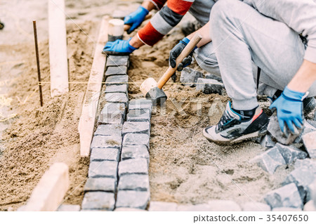 Industrial construction worker paving road Industrial construction worker paving road 35407650